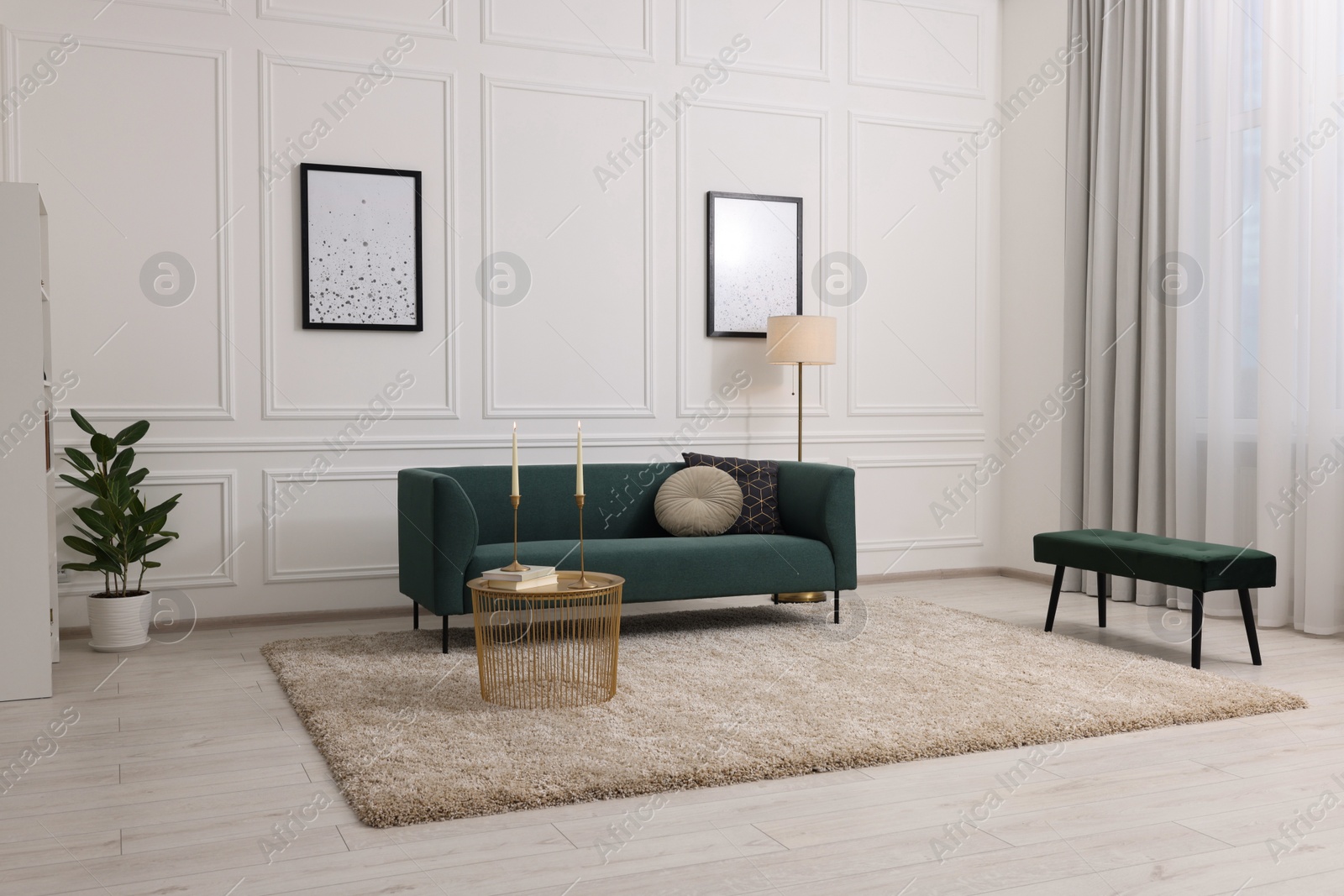 Photo of Stylish living room with soft beige carpet, coffee table and sofa. Interior design