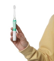 Photo of Woman holding electric toothbrush on white background, closeup