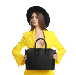 Beautiful young woman with stylish bag on white background