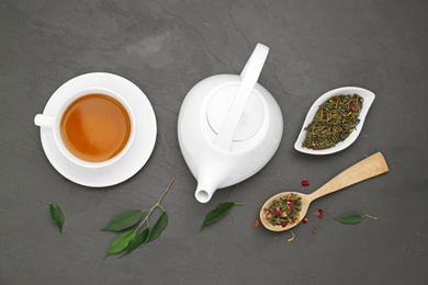 Composition with tea on black background, flat lay