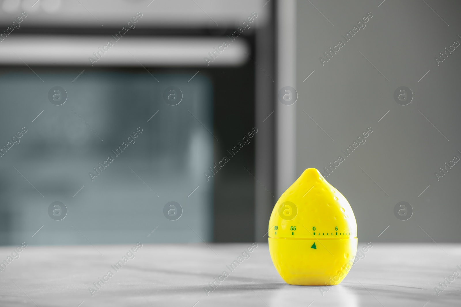 Photo of Kitchen timer in shape of lemon on light grey table indoors. Space for text