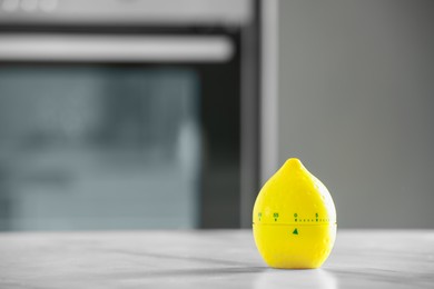 Kitchen timer in shape of lemon on light grey table indoors. Space for text