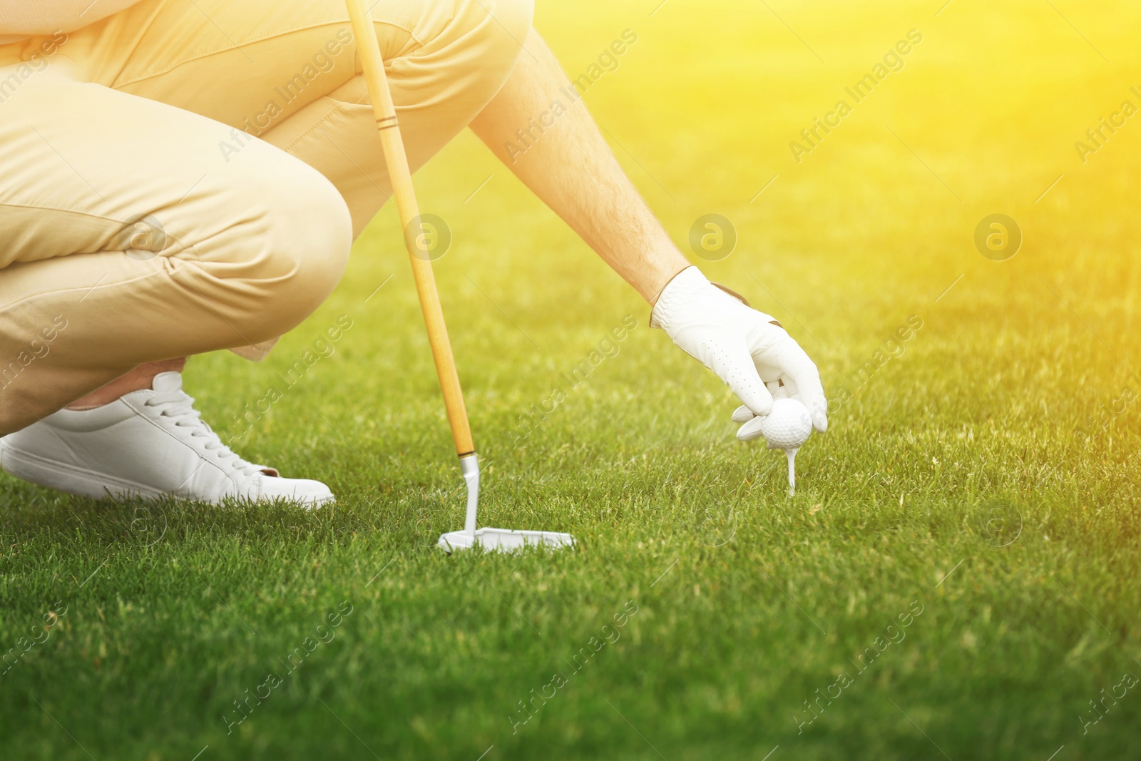 Image of Man playing golf in park on sunny day. Sport and leisure