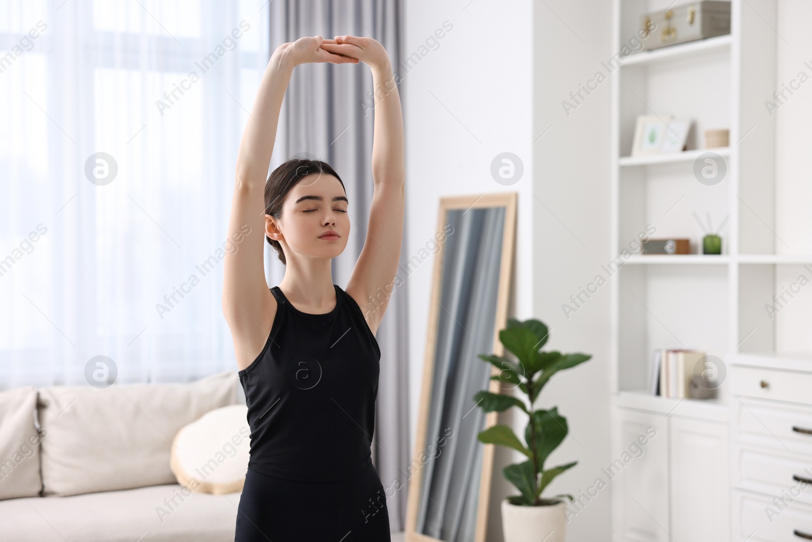 Photo of Portrait of beautiful girl practicing yoga at home