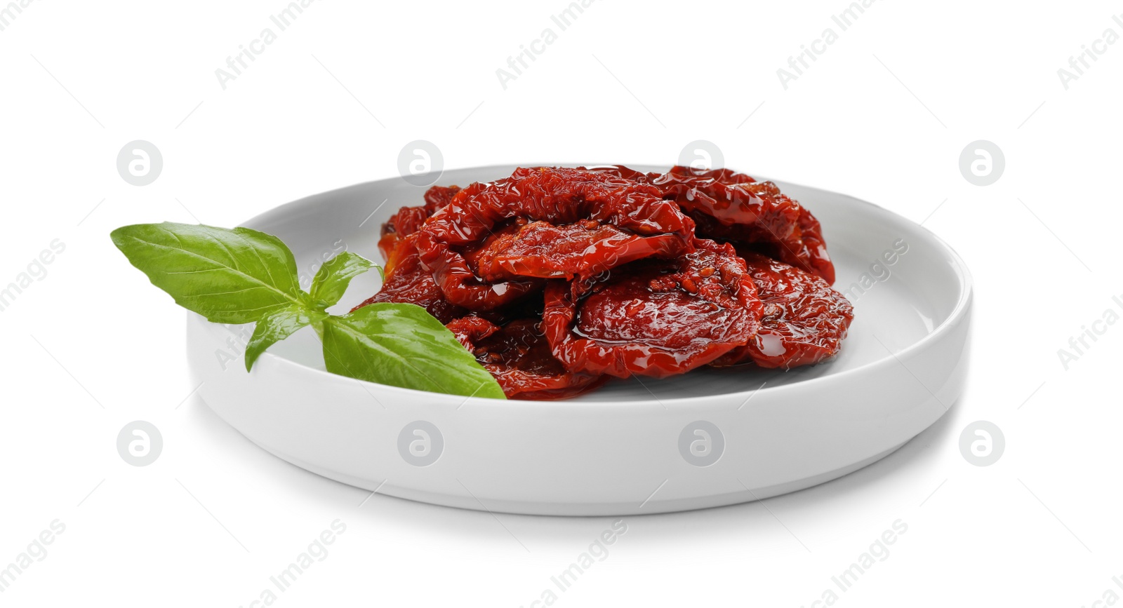 Photo of Plate with sun dried tomatoes on white background