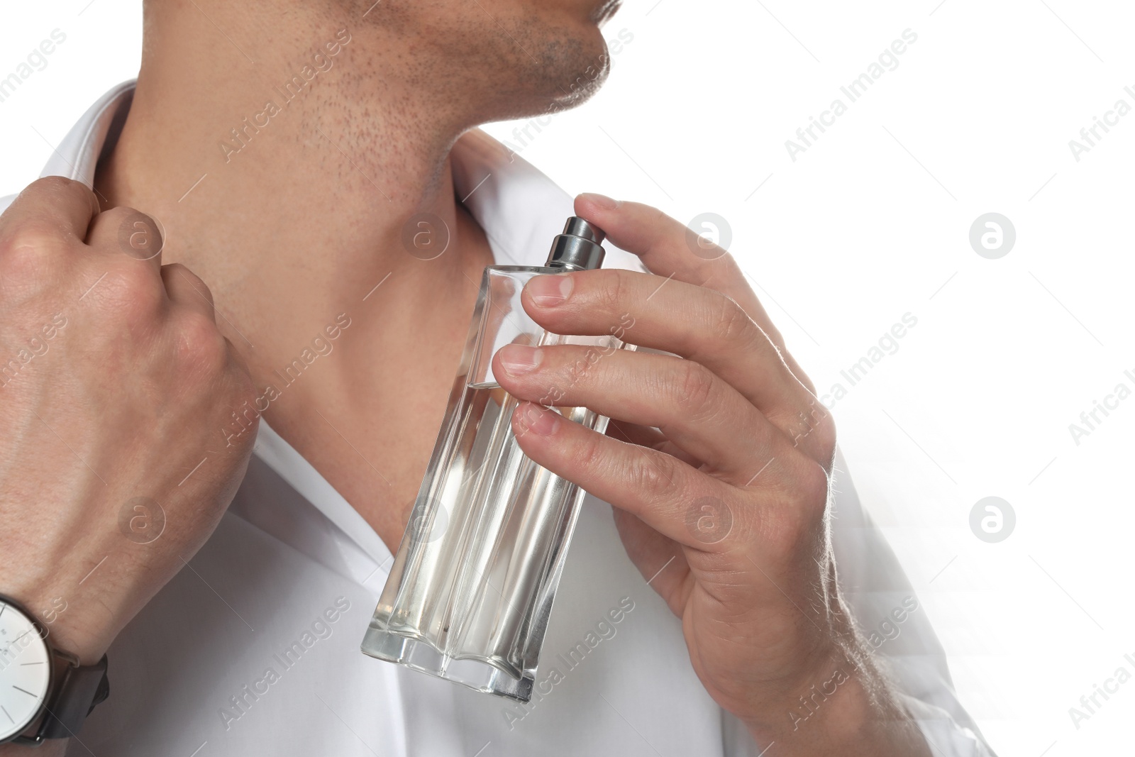 Photo of Handsome man applying perfume on neck against white background, closeup