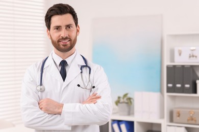 Medical consultant with stethoscope in clinic, space for text