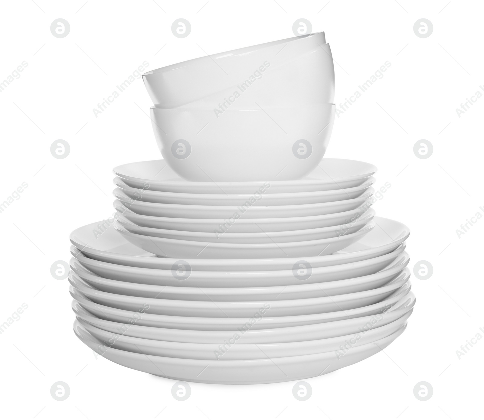 Photo of Stacked plates and cups on white background