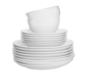 Photo of Stacked plates and cups on white background