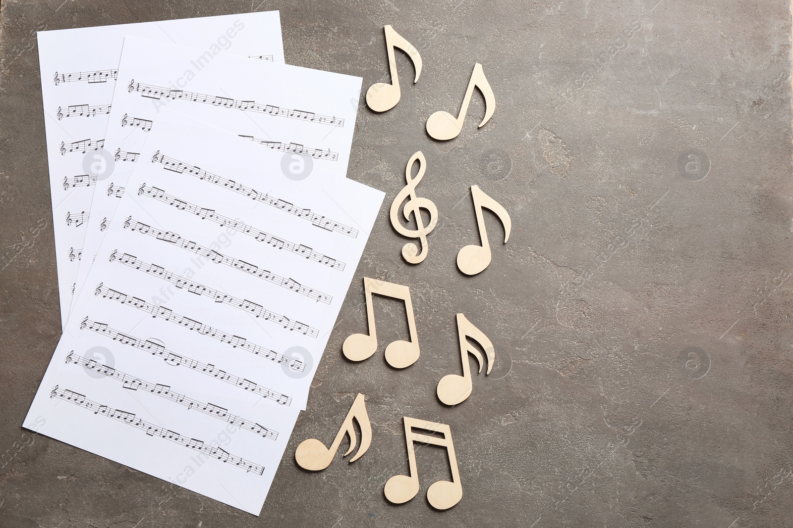 Photo of Sheets and music notes on color background, top view. Space for text