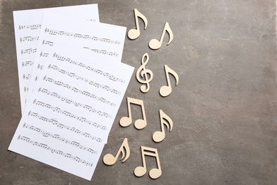 Sheets and music notes on color background, top view. Space for text