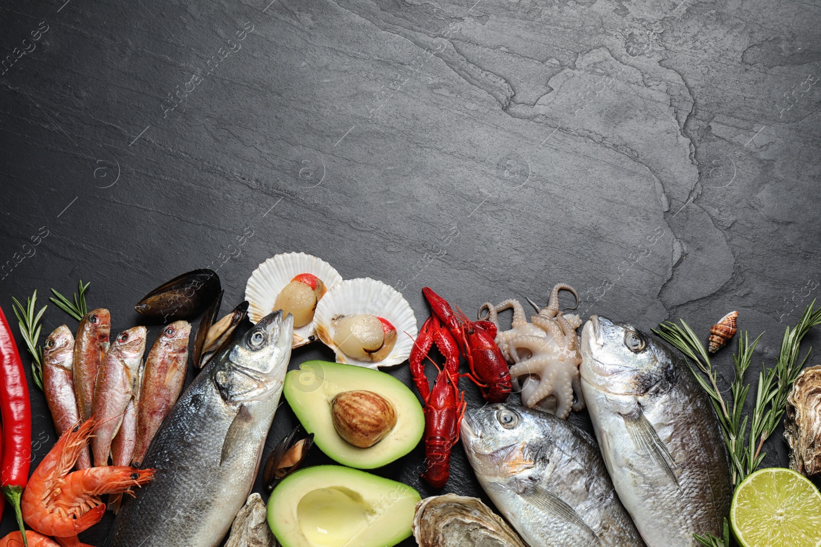 Photo of Fresh fish and different seafood on black table, flat lay. Space for text