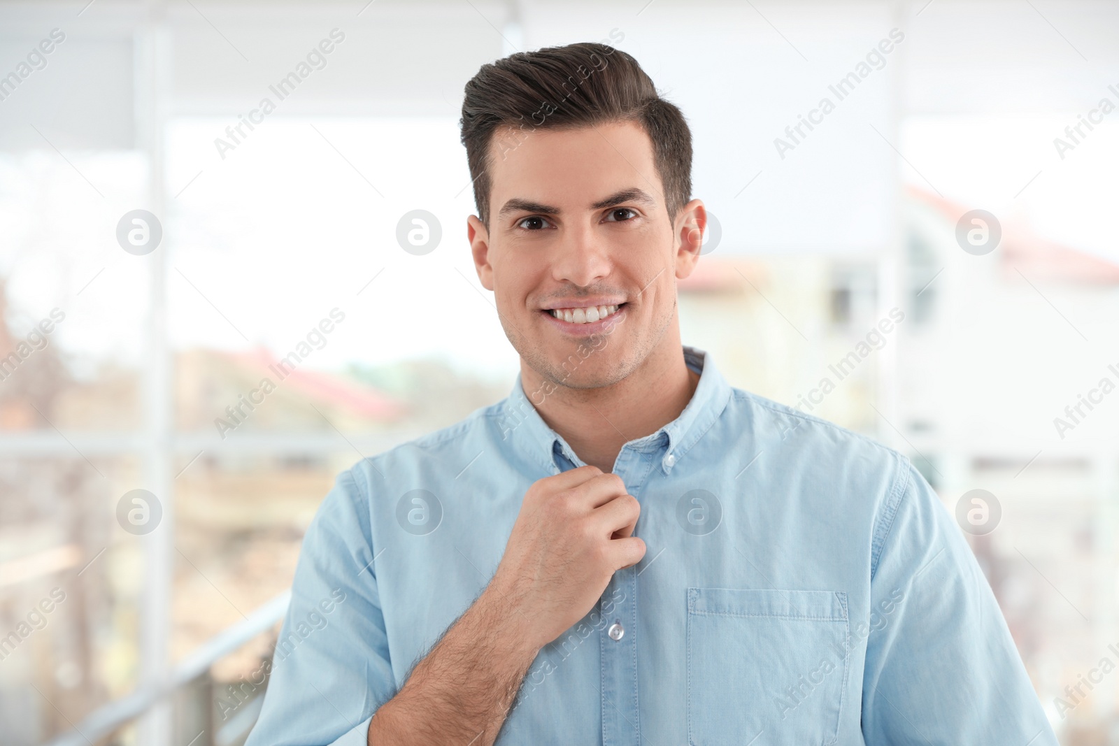 Photo of Portrait of handsome man smiling in light room