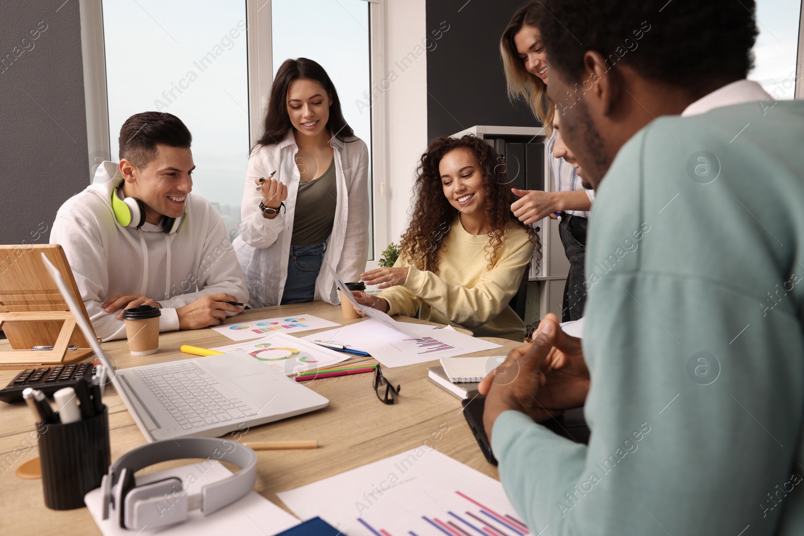 Photo of Team of employees working together in office. Startup project