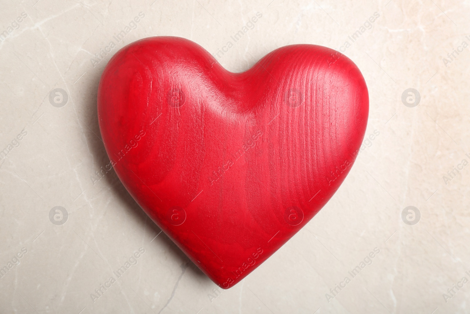 Photo of Red decorative heart as symbol of love on color background, top view