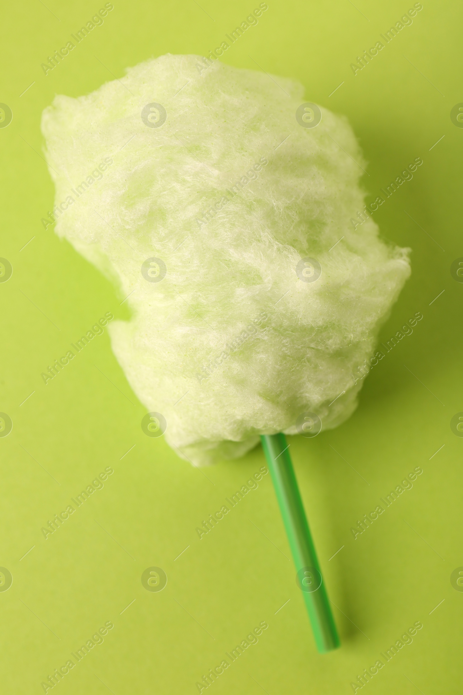 Photo of Sweet cotton candy on green background, above view