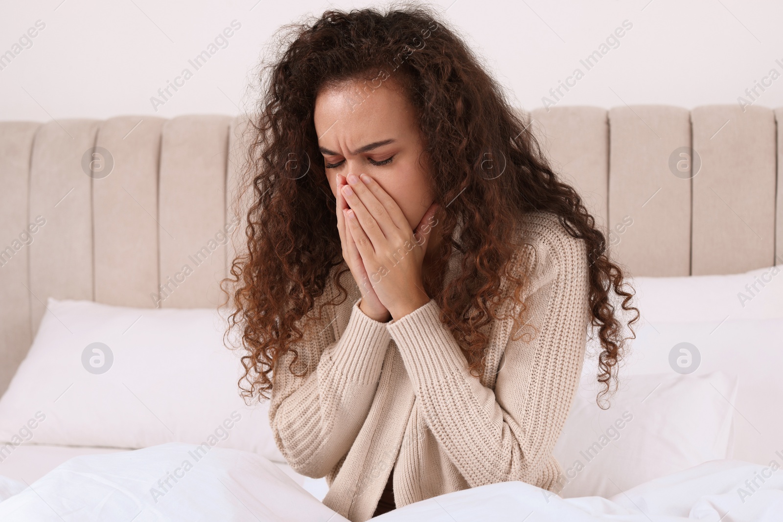 Photo of Sick African American woman in bed at home