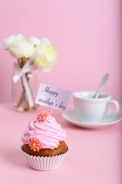 Photo of Topper with words HAPPY MOTHER'S DAY in cupcake on table