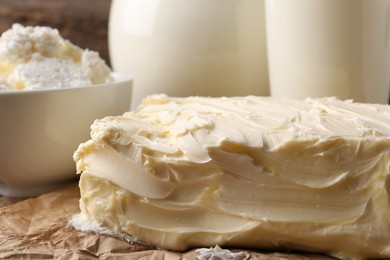 Tasty homemade butter and dairy products on parchment, closeup