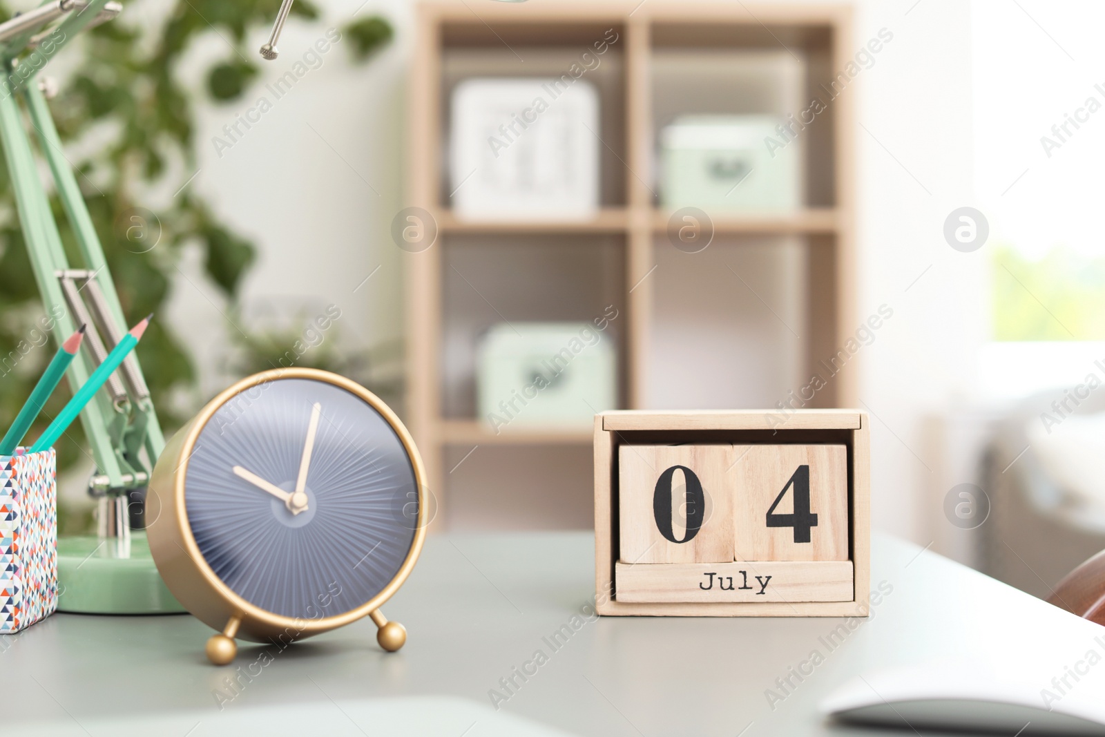 Photo of Stylish alarm clock on table in office. Time to work