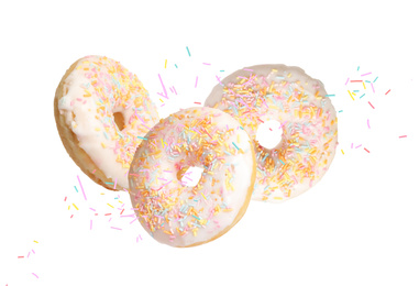 Image of Set of falling delicious donuts on white background