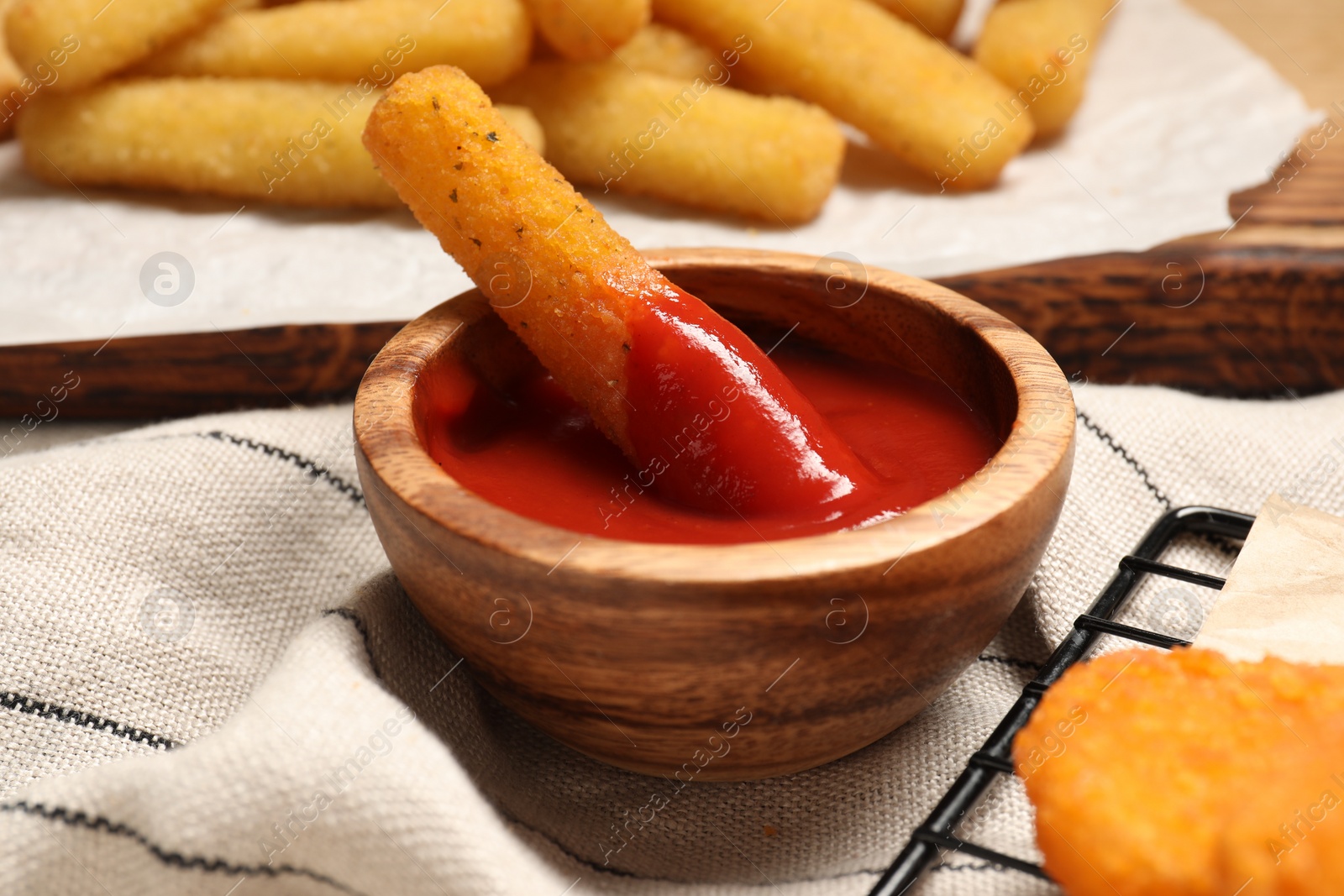 Photo of Delicious cheese stick with ketchup on table, closeup