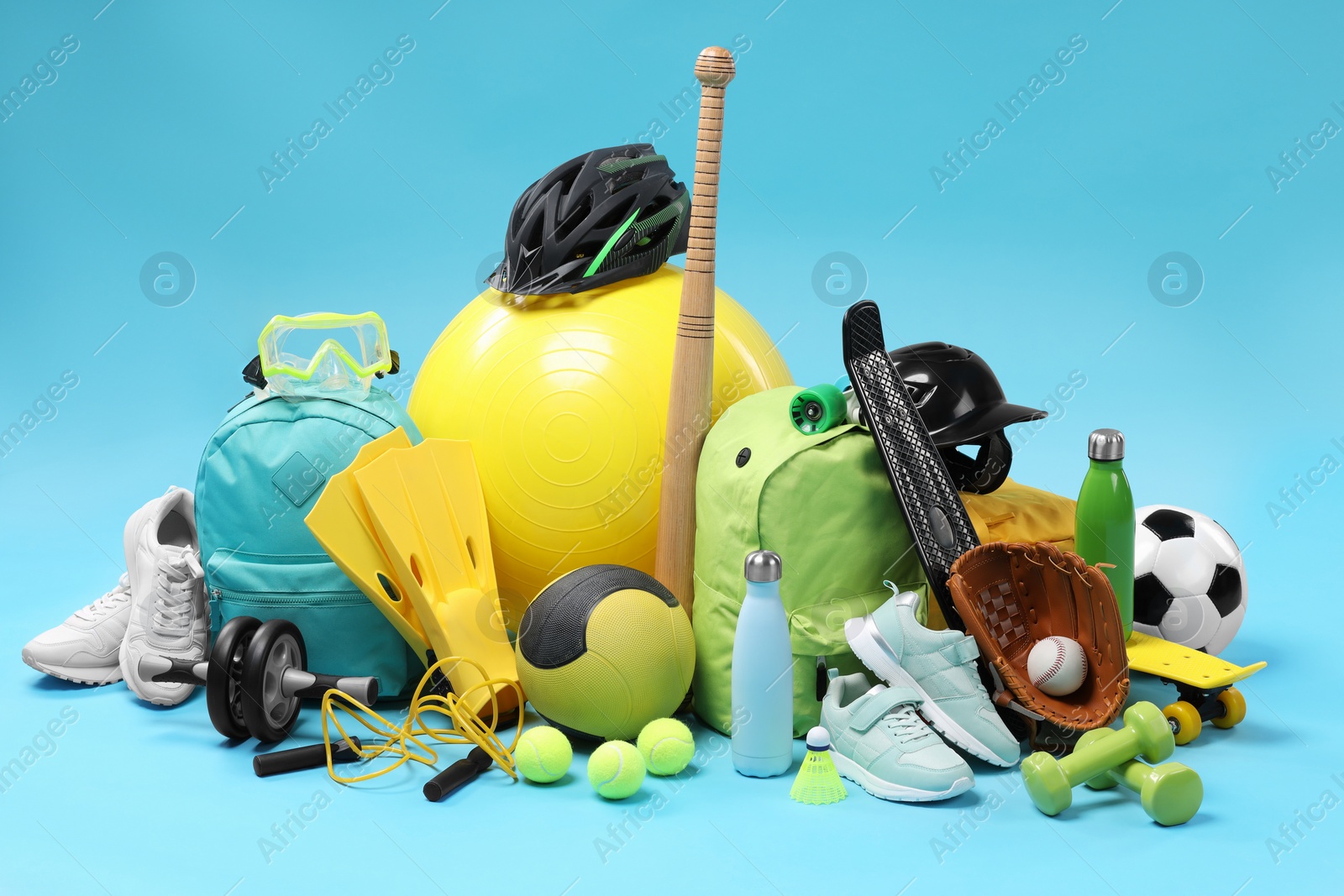 Photo of Many different sports equipment on light blue background