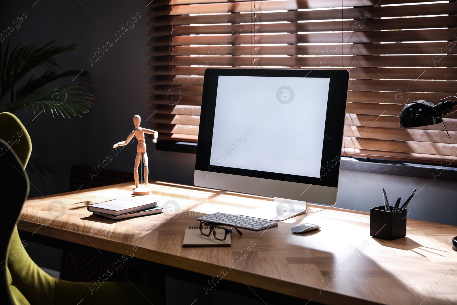 Photo of Stylish room interior with modern computer and comfortable office chair