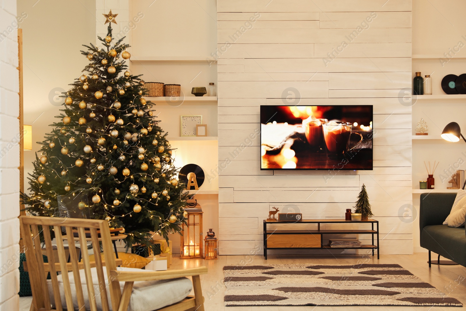 Photo of Plasma TV on white wooden wall in living room beautifully decorated for Christmas