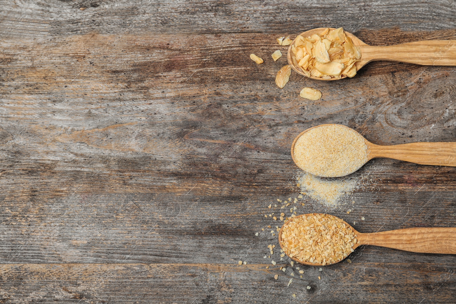 Photo of Flat lay composition with dried garlic products on wooden background