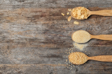 Flat lay composition with dried garlic products on wooden background