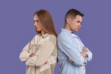Photo of Portrait of resentful couple with crossed arms on violet background