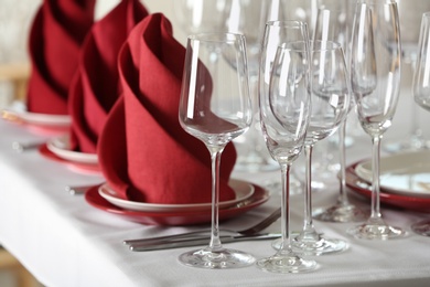 Photo of Table setting with empty glasses, plates and cutlery on table