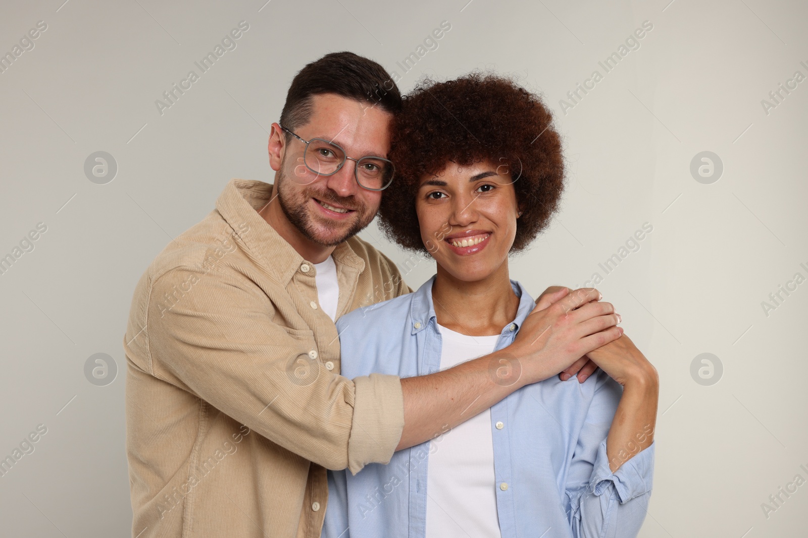 Photo of International dating. Portrait of lovely couple on light grey background