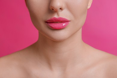 Photo of Closeup view of woman with beautiful lips on pink background