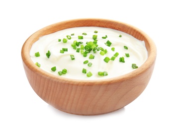 Photo of Bowl with sour cream and herbs on white background