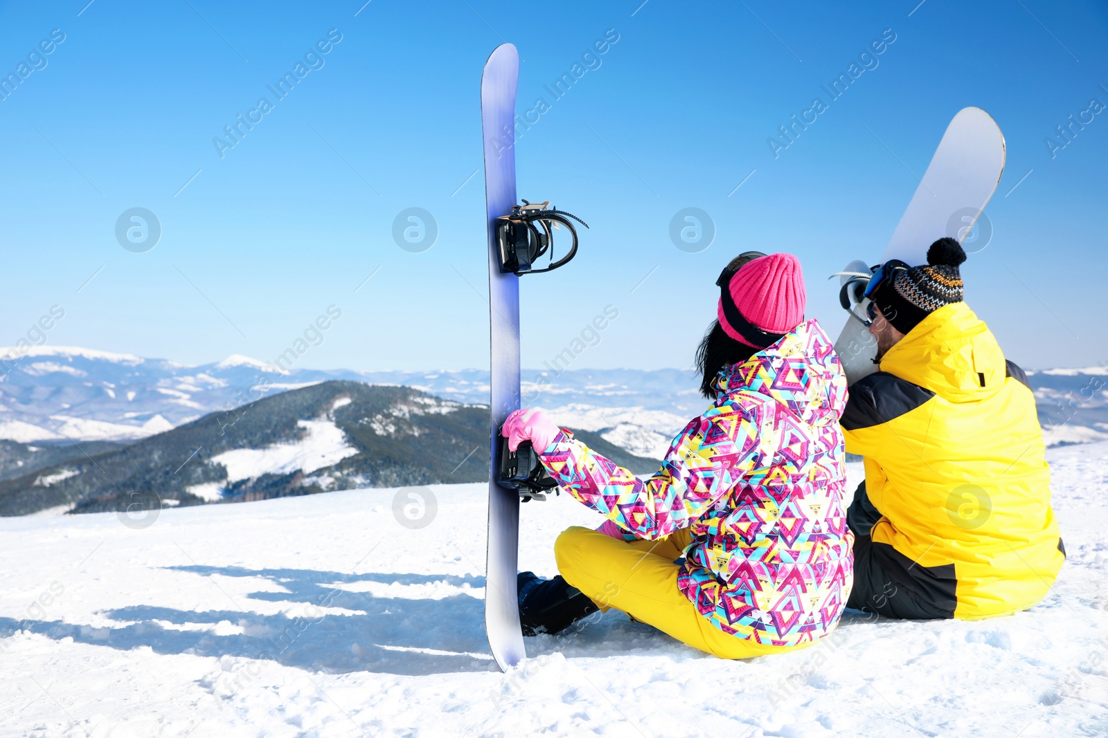 Photo of Couple with snowboards on hill, space for text. Winter vacation