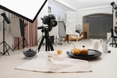 Professional equipment and composition with delicious dessert on wooden table in studio. Food photography