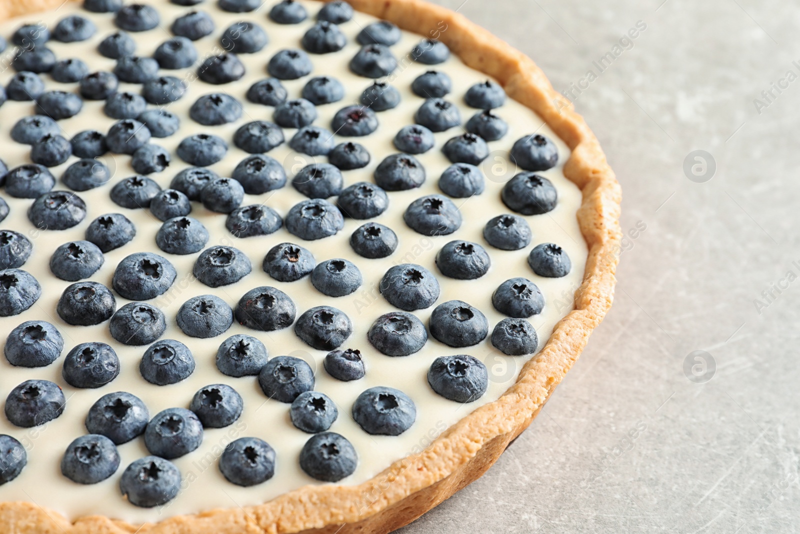 Photo of Tasty blueberry cake on gray background, closeup view