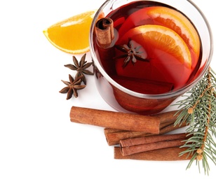 Photo of Composition with glass cup of mulled wine, cinnamon, orange and fir branch on white background