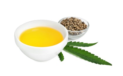 Photo of Hemp oil, fresh leaf and seeds on white background