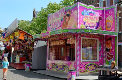 Netherlands, Groningen - May 18, 2022: Stall with delicious sweet snacks in amusement park