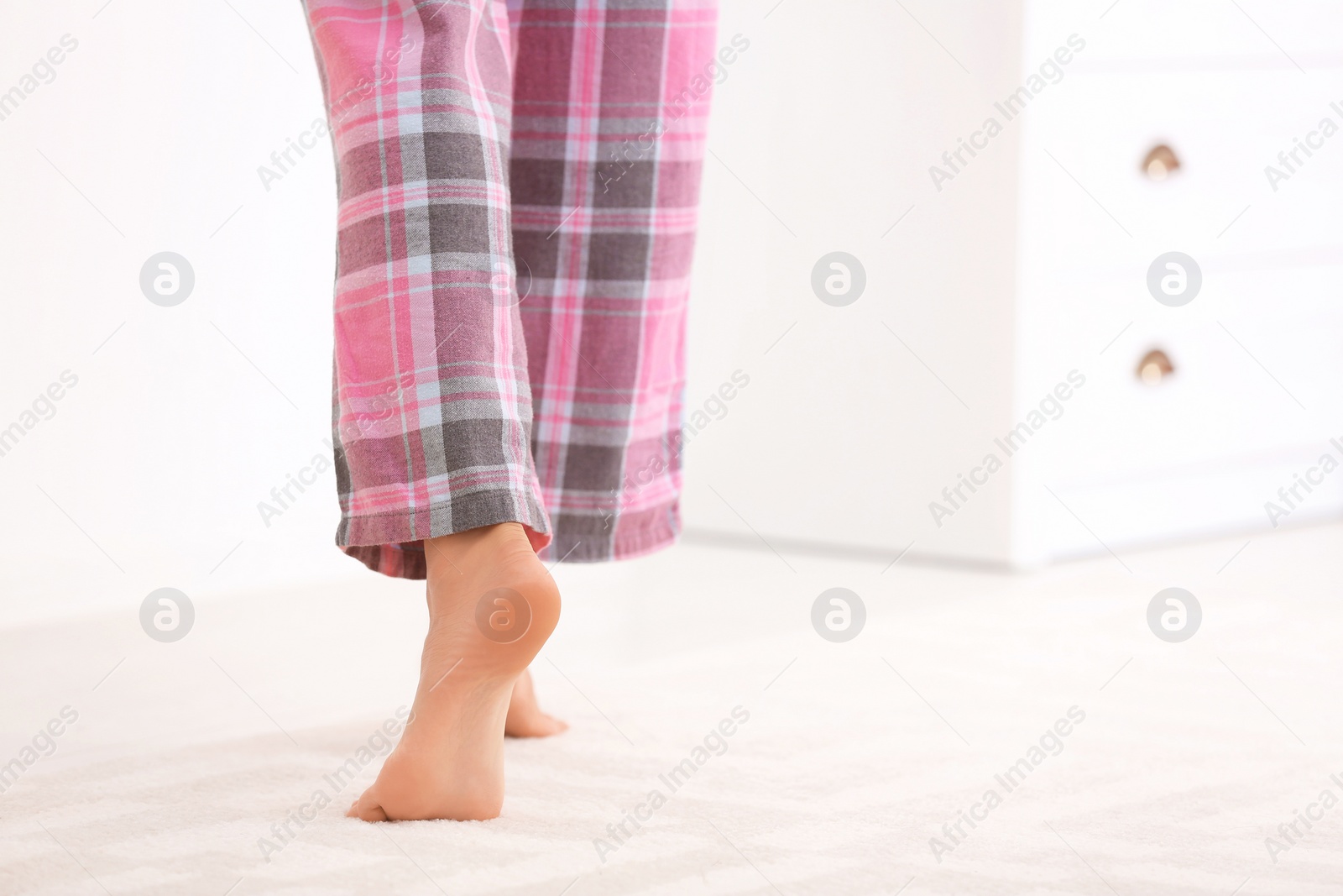 Photo of Woman walking barefoot in apartment, closeup. Floor heating