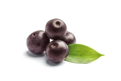 Photo of Fresh acai berries with leaves on white background