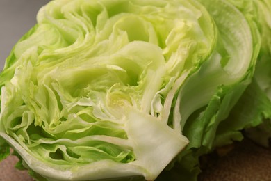 Half of fresh green iceberg lettuce head on table, closeup