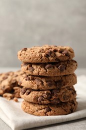 Photo of Delicious chocolate chip cookies on light grey table