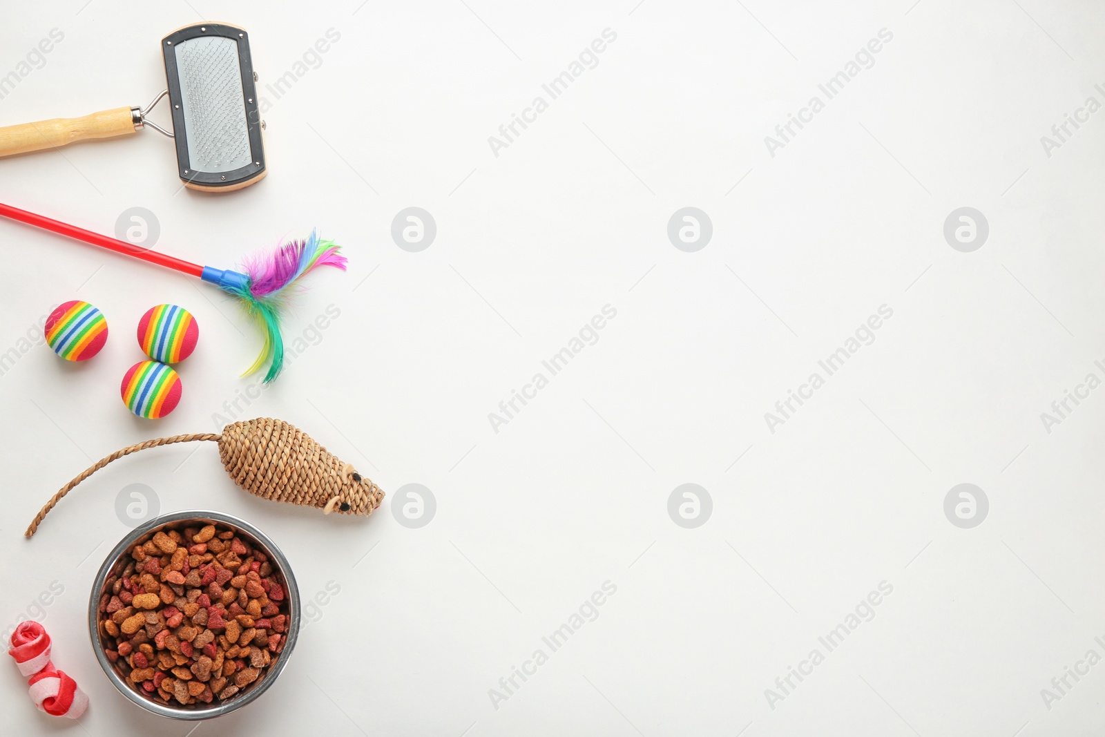 Photo of Cat's accessories and food on white background