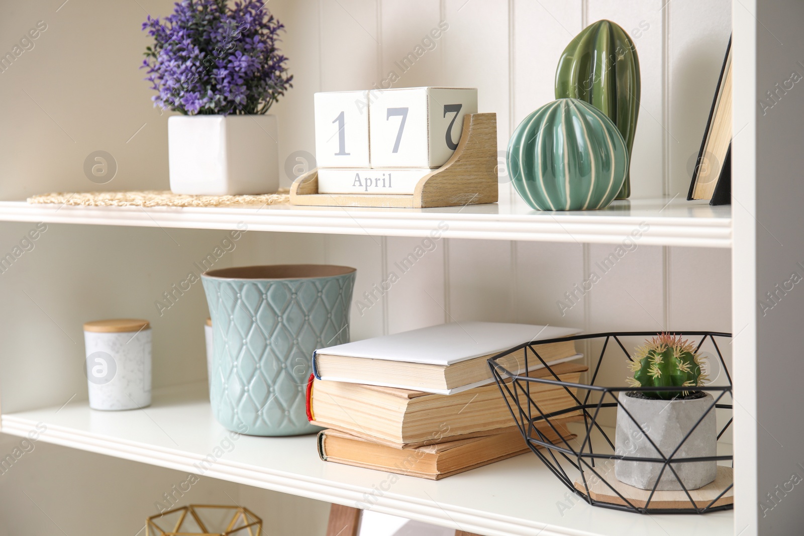 Photo of White shelving unit with books and different decorative stuff