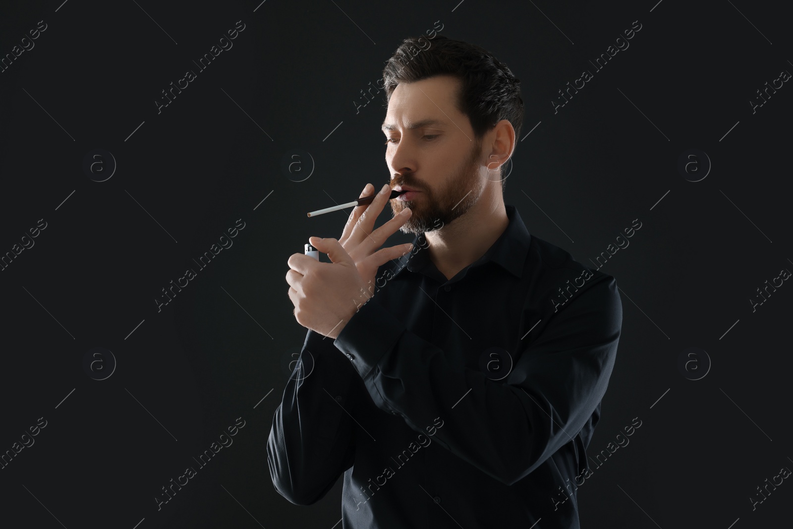 Photo of Man using cigarette holder for smoking on black background, space for text