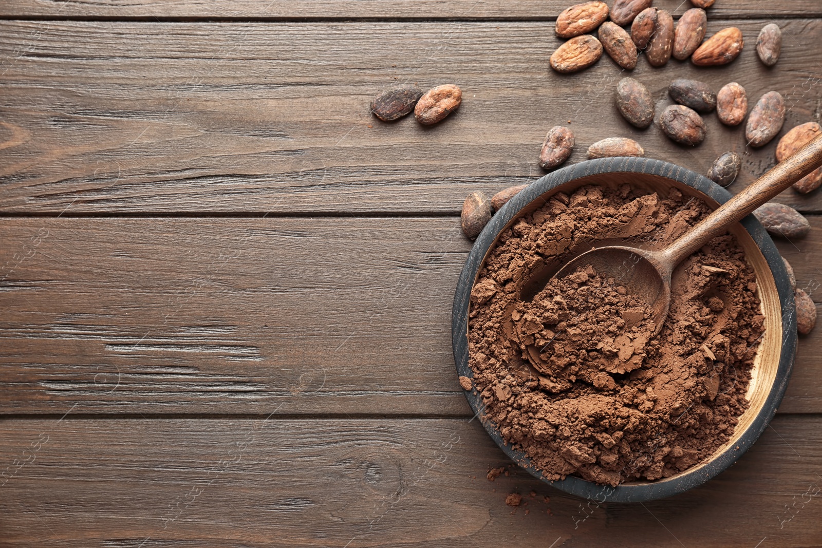 Photo of Flat lay composition with cocoa powder and beans on wooden background